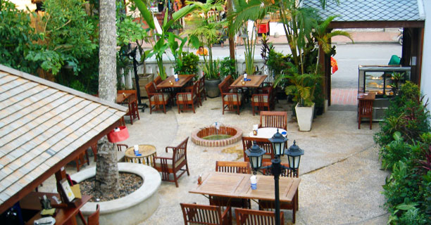 Front view of the garden from the main building of the coconut garden restaurant - luang prabang - Laos